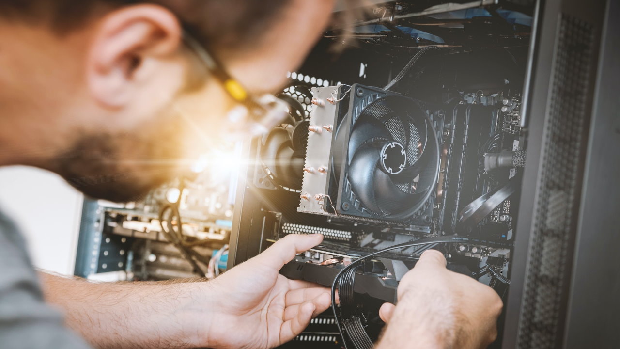 Man replacing a computer component